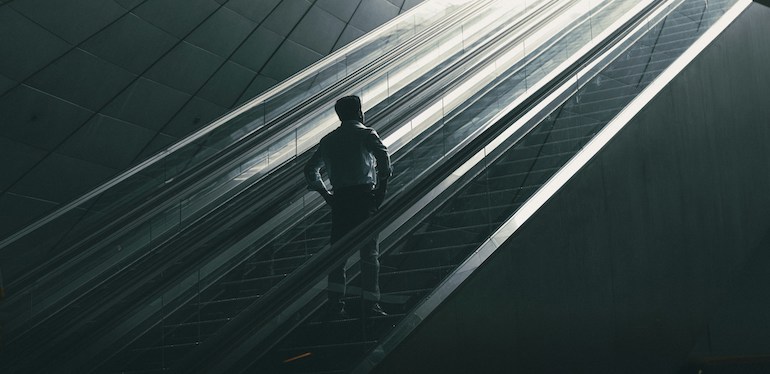 man looking up a flight of stairs